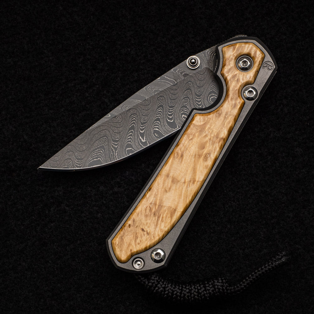 CHRIS REEVE SMALL SEBENZA 31 BOX ELDER BURL INLAY - BOOMERANG BLADE - SILVER DOUBLE THUMB LUGS