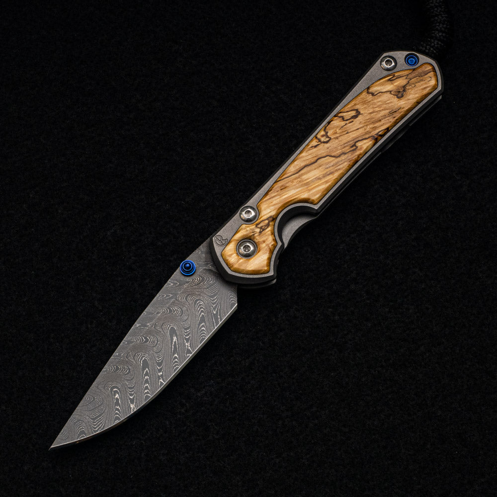 CHRIS REEVE SMALL SEBENZA 31 BOX ELDER BURL INLAY - BOOMERANG BLADE - BLUE DOUBLE THUMB LUGS