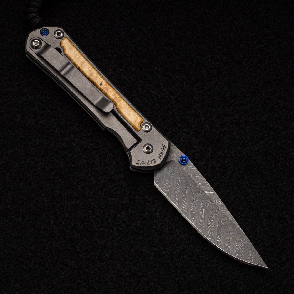 CHRIS REEVE SMALL SEBENZA 31 BOX ELDER BURL INLAY - BOOMERANG BLADE - BLUE DOUBLE THUMB LUGS