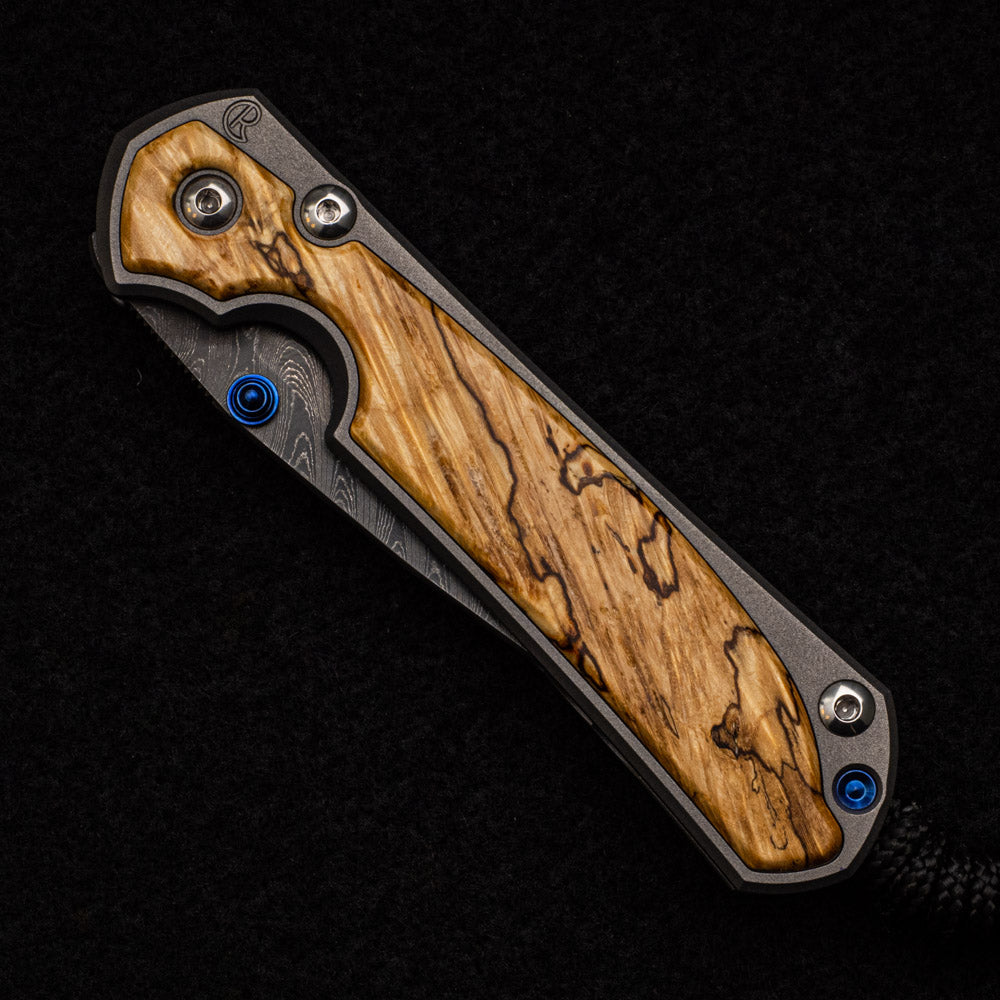 CHRIS REEVE SMALL SEBENZA 31 BOX ELDER BURL INLAY - BOOMERANG BLADE - BLUE DOUBLE THUMB LUGS