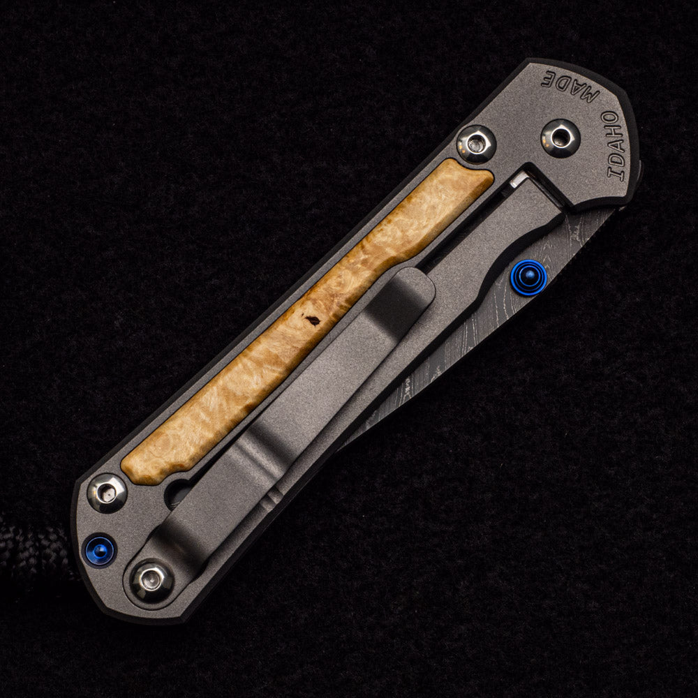 CHRIS REEVE SMALL SEBENZA 31 BOX ELDER BURL INLAY - BOOMERANG BLADE - BLUE DOUBLE THUMB LUGS