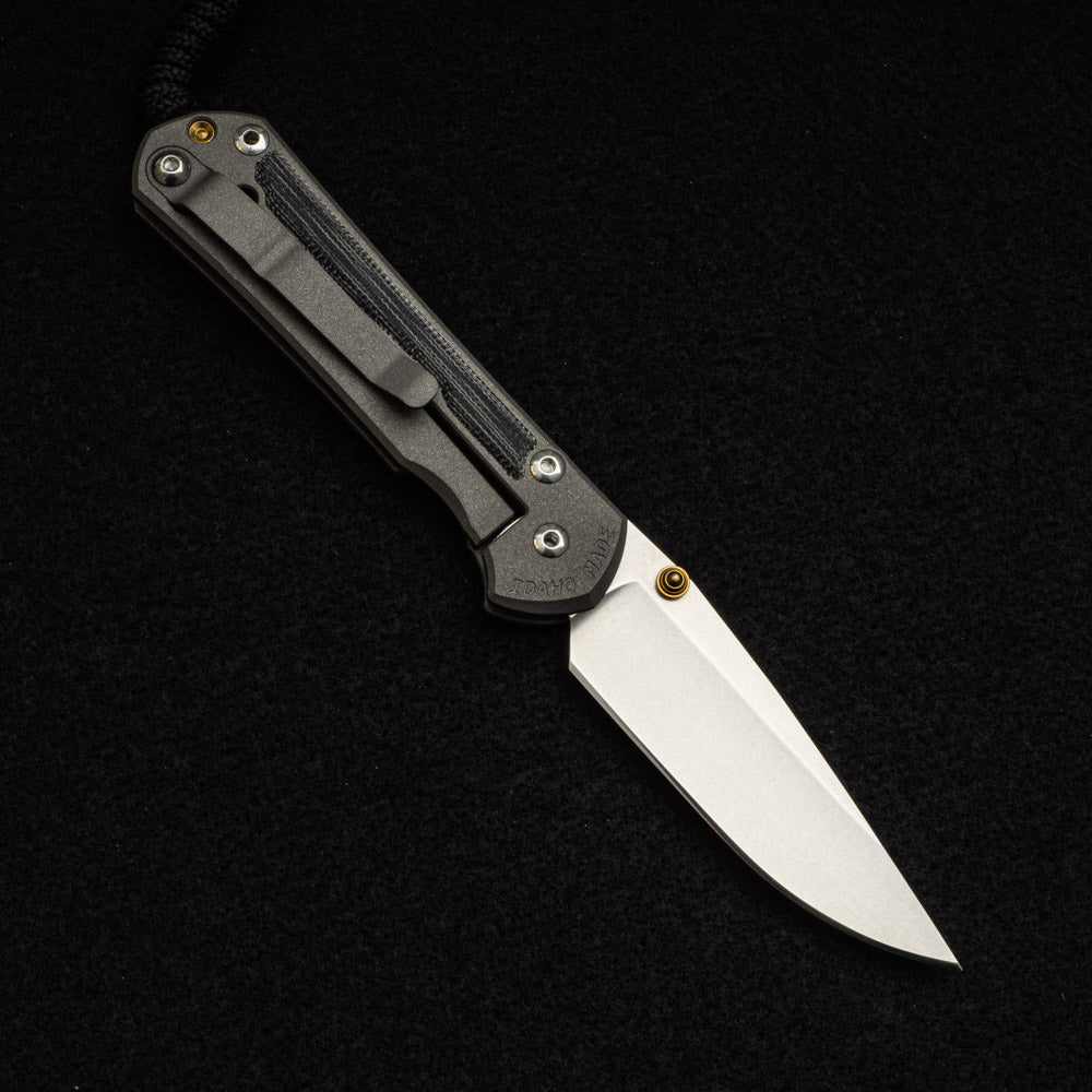 CHRIS REEVE SMALL SEBENZA 31 BLACK CANVAS MICARTA INLAY – CPM MAGNACUT BLADE – GOLD DOUBLE THUMB LUGS