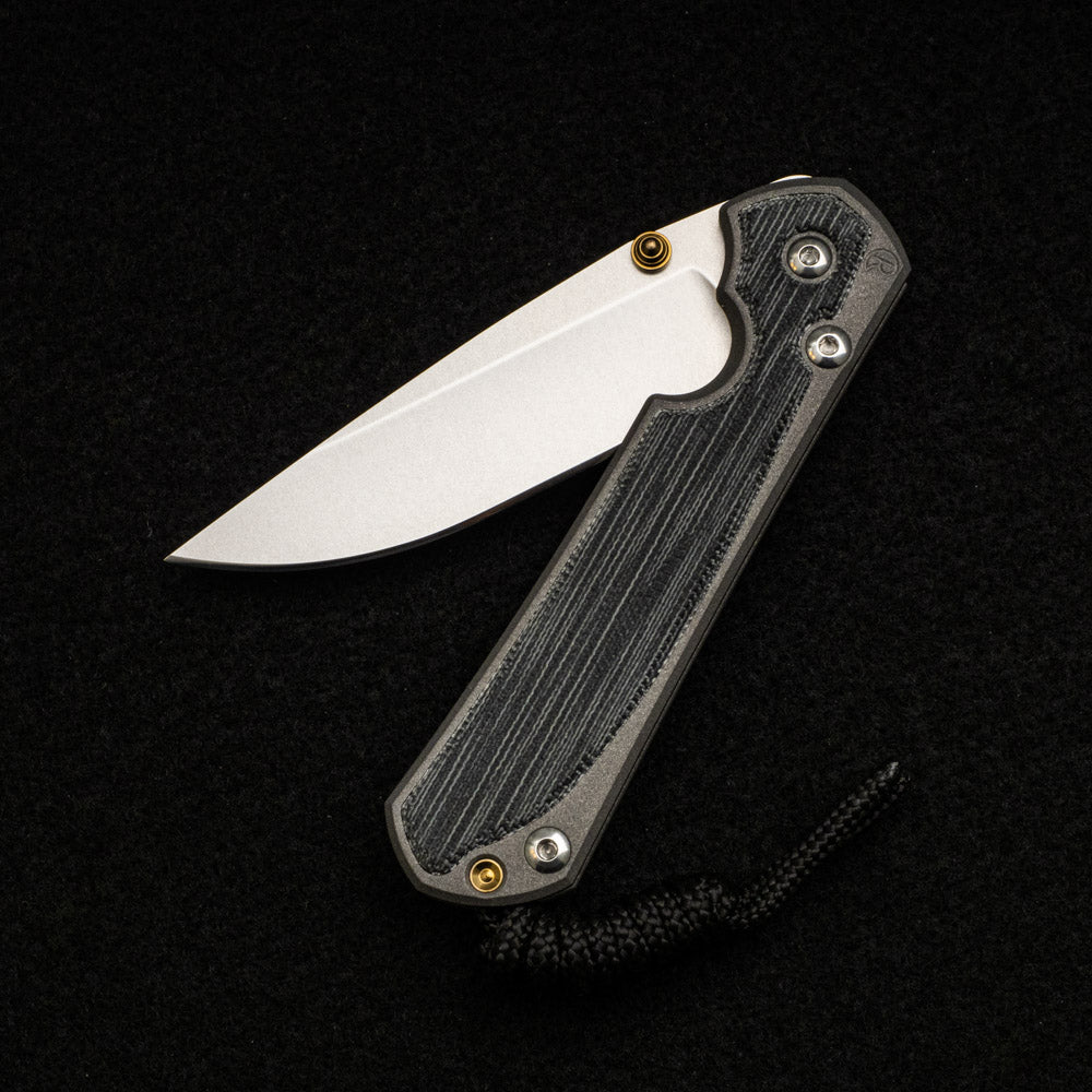 CHRIS REEVE SMALL SEBENZA 31 BLACK CANVAS MICARTA INLAY – CPM MAGNACUT BLADE – GOLD DOUBLE THUMB LUGS