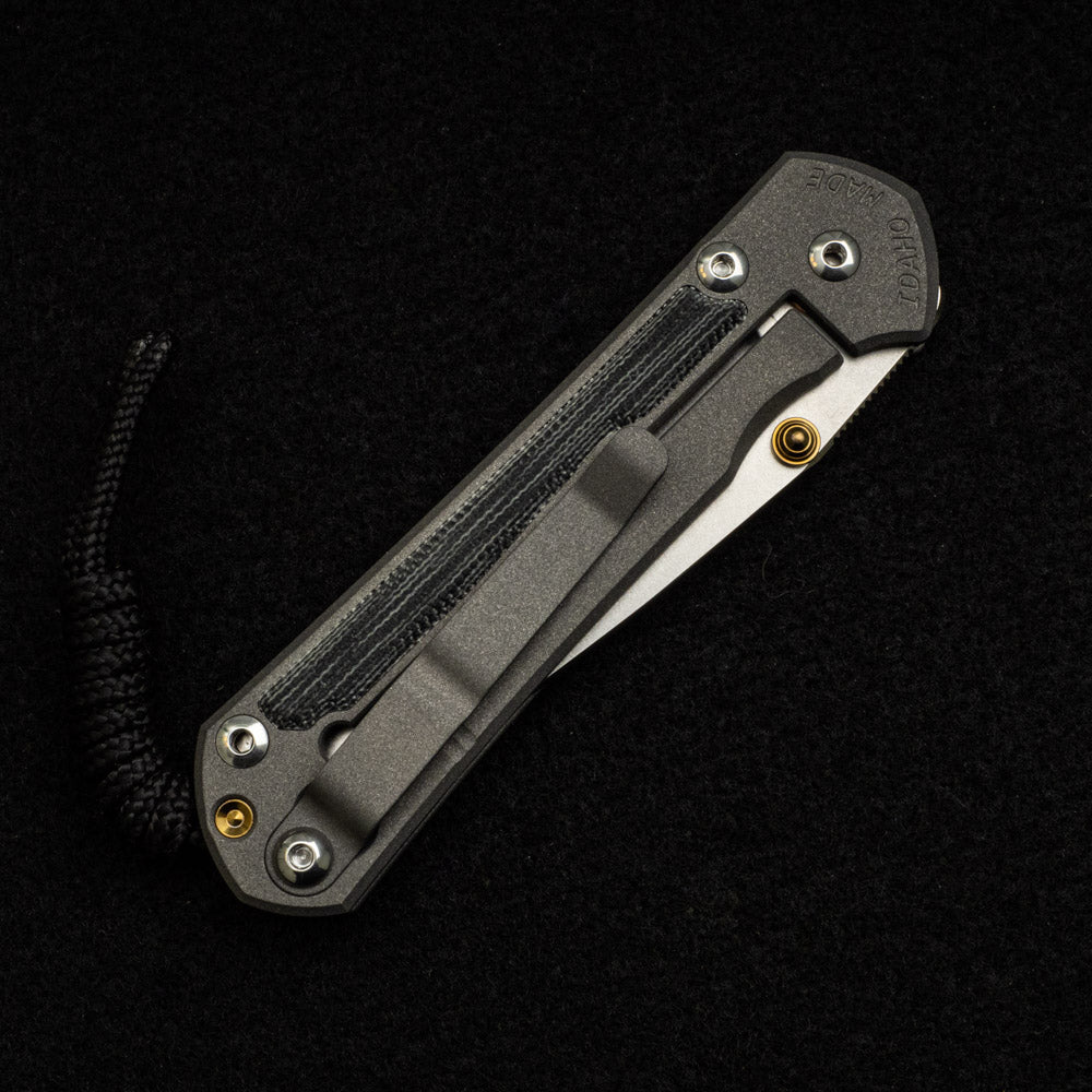 CHRIS REEVE SMALL SEBENZA 31 BLACK CANVAS MICARTA INLAY – CPM MAGNACUT BLADE – GOLD DOUBLE THUMB LUGS