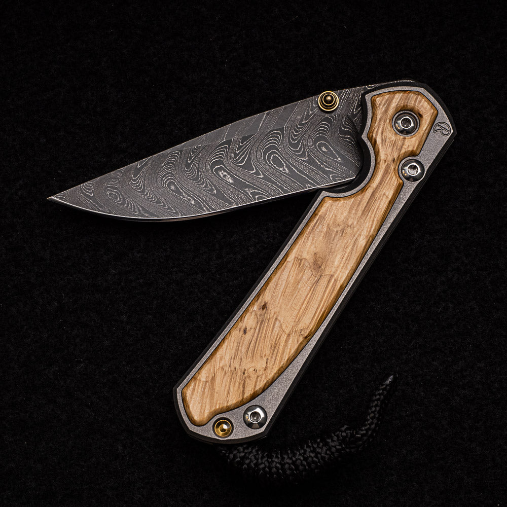 CHRIS REEVE SMALL SEBENZA 31 BOX ELDER INLAY - BOOMERANG BLADE - GOLD DOUBLE THUMB LUGS