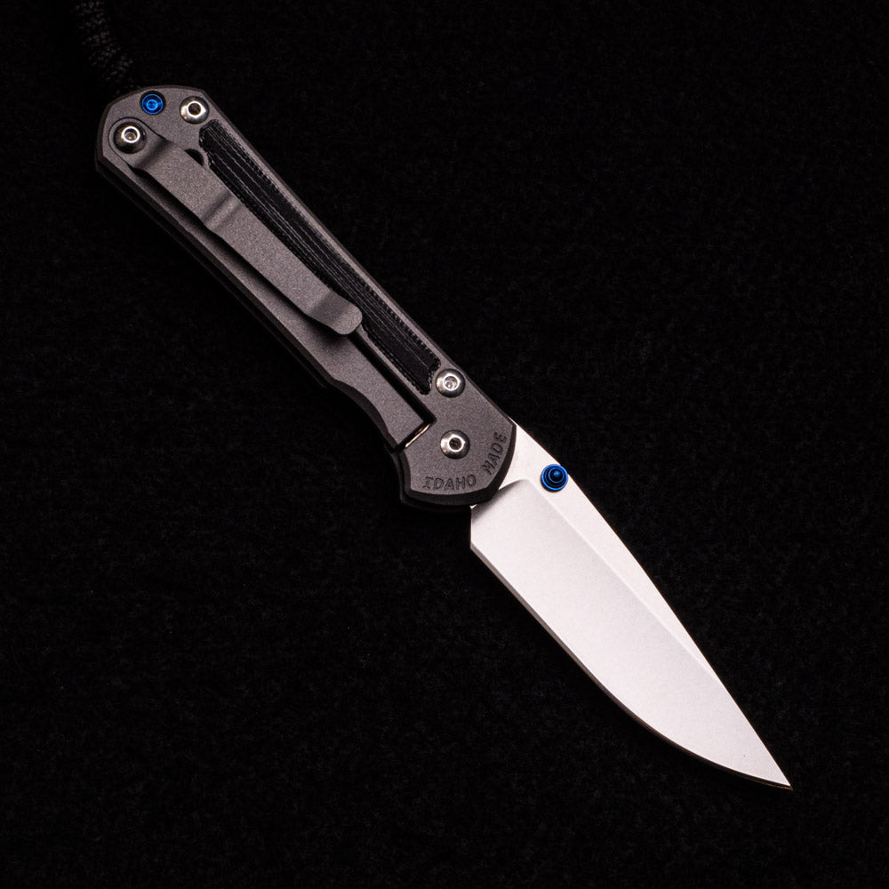 CHRIS REEVE SMALL SEBENZA 31 BLACK CANVAS MICARTA INLAY – CPM MAGNACUT BLADE – BLUE DOUBLE THUMB LUGS