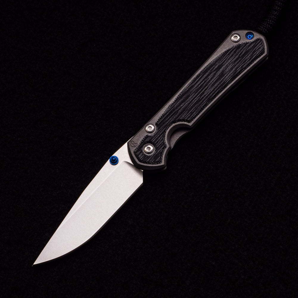 CHRIS REEVE SMALL SEBENZA 31 BLACK CANVAS MICARTA INLAY – CPM MAGNACUT BLADE – BLUE DOUBLE THUMB LUGS