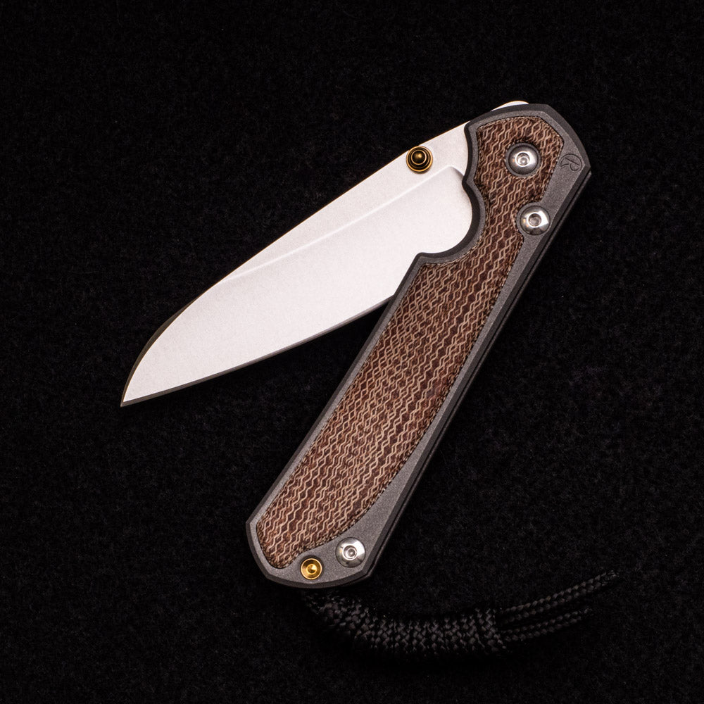 CHRIS REEVE SMALL SEBENZA 31 NATURAL CANVAS MICARTA INLAY – CPM MAGNACUT INSINGO BLADE – GOLD DOUBLE THUMB LUGS