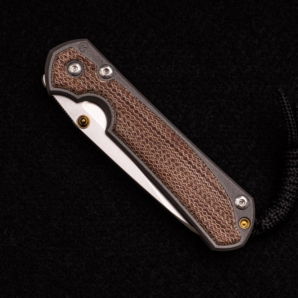 CHRIS REEVE SMALL SEBENZA 31 NATURAL CANVAS MICARTA INLAY – CPM MAGNACUT INSINGO BLADE – GOLD DOUBLE THUMB LUGS