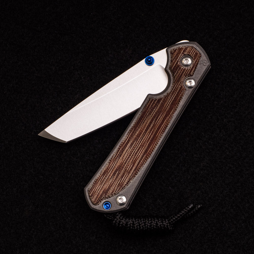 CHRIS REEVE SMALL SEBENZA 31 NATURAL CANVAS MICARTA INLAY – CPM MAGNACUT TANTO BLADE – BLUE DOUBLE THUMB LUGS