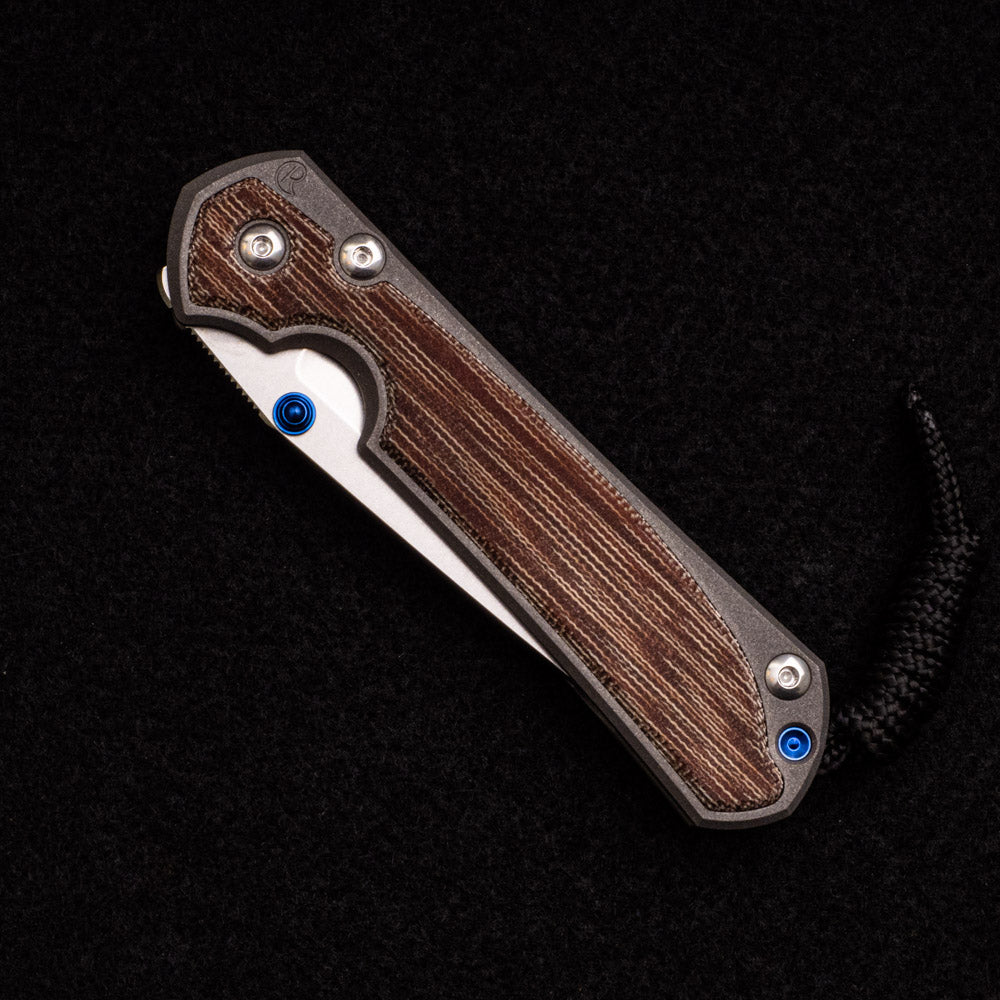 CHRIS REEVE SMALL SEBENZA 31 NATURAL CANVAS MICARTA INLAY – CPM MAGNACUT TANTO BLADE – BLUE DOUBLE THUMB LUGS