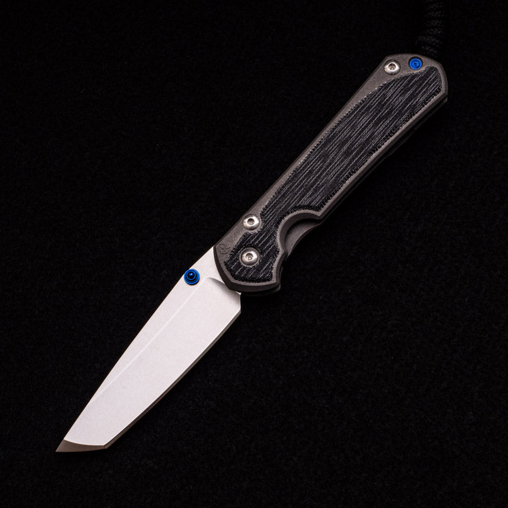 CHRIS REEVE SMALL SEBENZA 31 BLACK CANVAS MICARTA INLAY – CPM MAGNACUT TANTO BLADE – BLUE DOUBLE THUMB LUGS