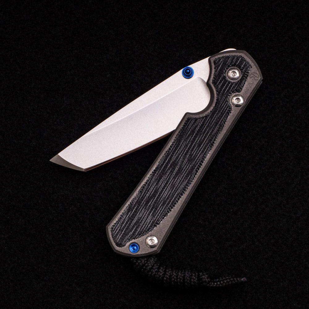 CHRIS REEVE SMALL SEBENZA 31 BLACK CANVAS MICARTA INLAY – CPM MAGNACUT TANTO BLADE – BLUE DOUBLE THUMB LUGS