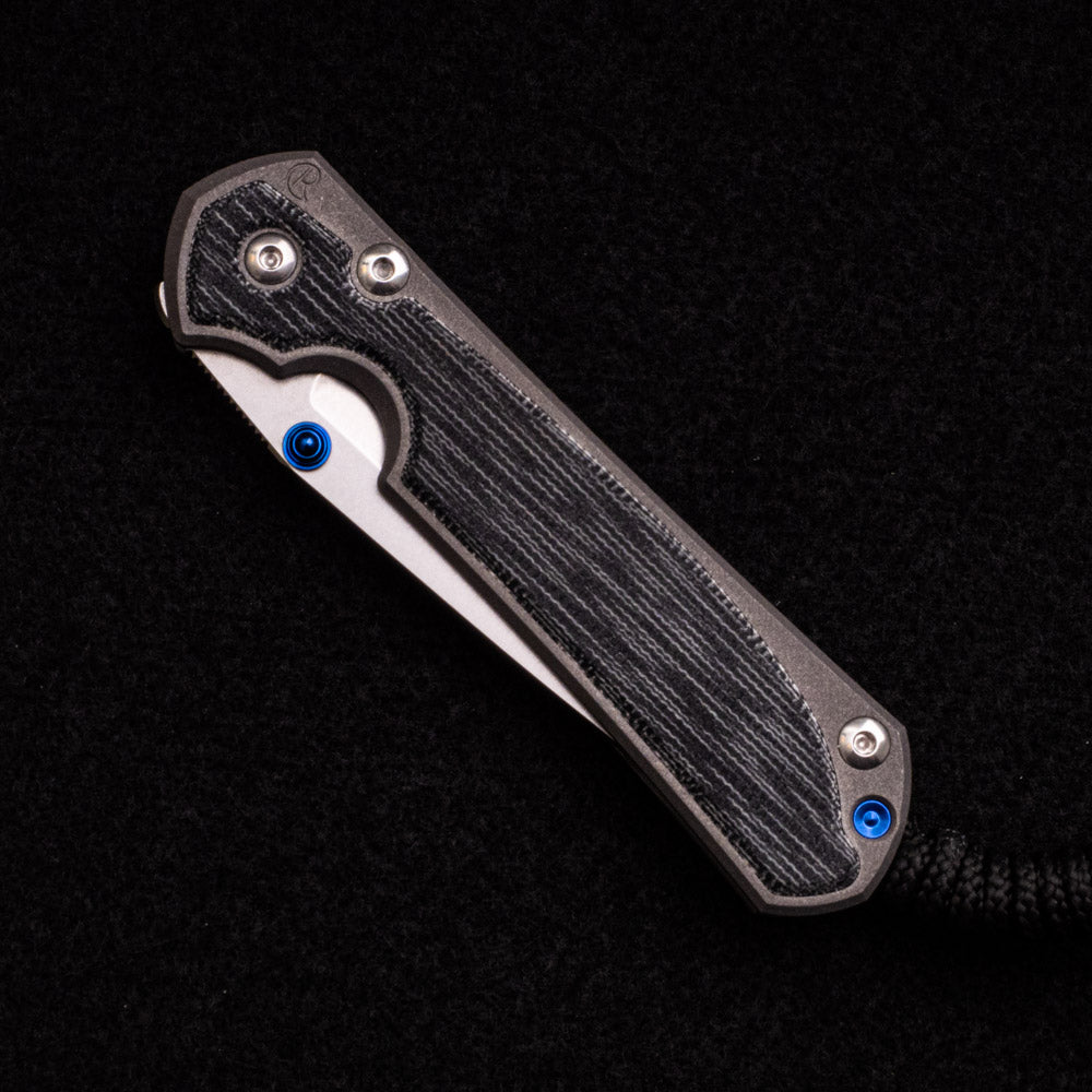 CHRIS REEVE SMALL SEBENZA 31 BLACK CANVAS MICARTA INLAY – CPM MAGNACUT TANTO BLADE – BLUE DOUBLE THUMB LUGS