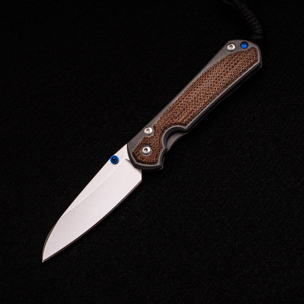 CHRIS REEVE SMALL SEBENZA 31 NATURAL CANVAS MICARTA INLAY – CPM MAGNACUT INSINGO BLADE – BLUE DOUBLE THUMB LUGS