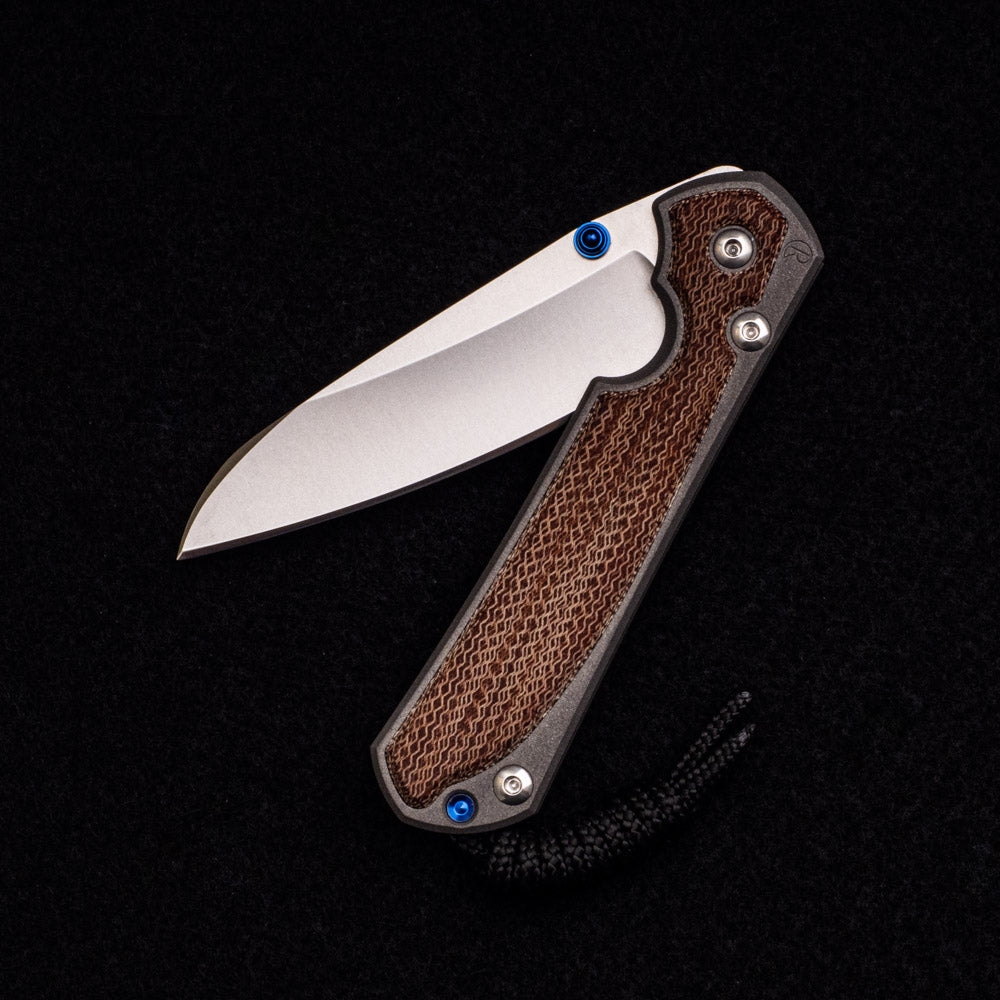 CHRIS REEVE SMALL SEBENZA 31 NATURAL CANVAS MICARTA INLAY – CPM MAGNACUT INSINGO BLADE – BLUE DOUBLE THUMB LUGS