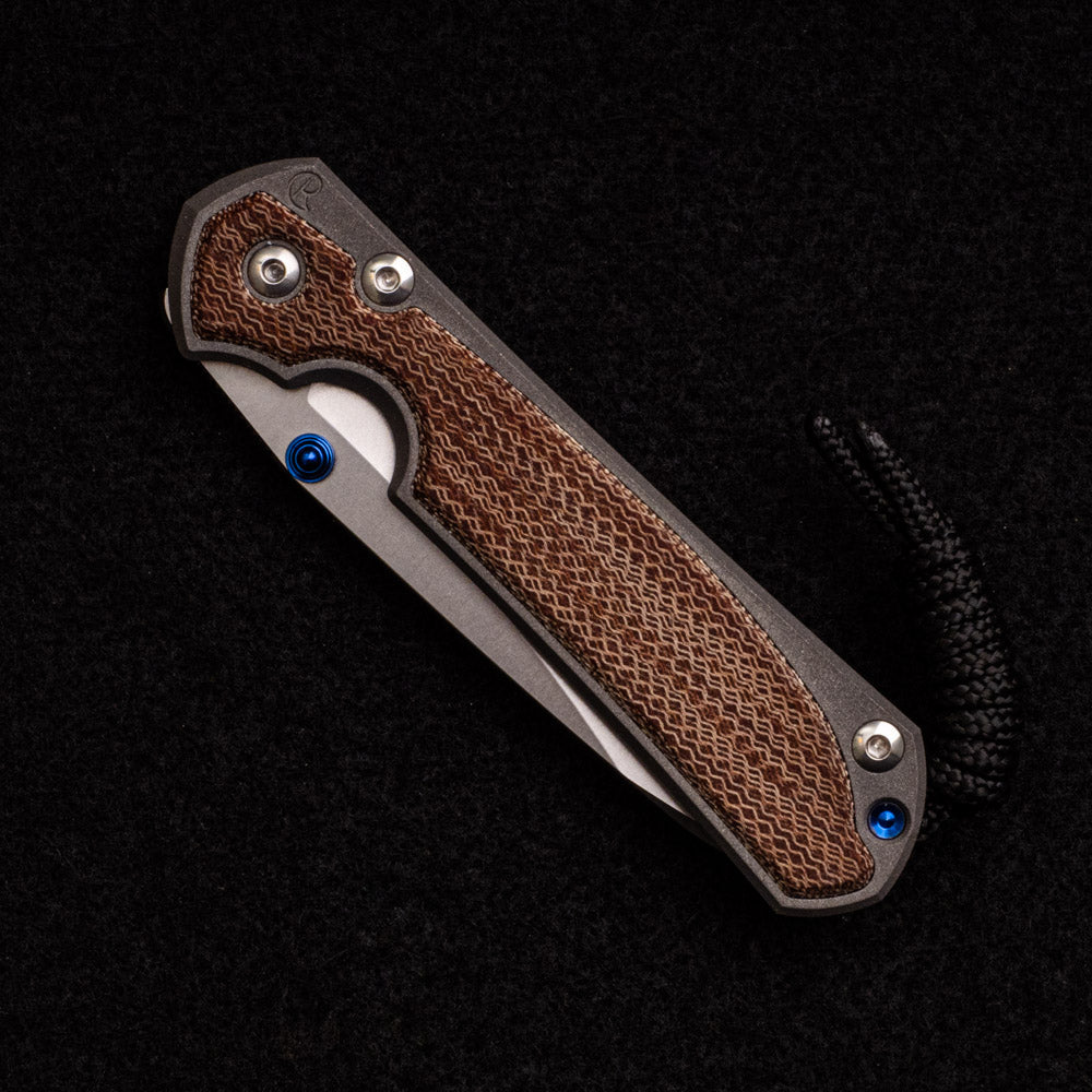 CHRIS REEVE SMALL SEBENZA 31 NATURAL CANVAS MICARTA INLAY – CPM MAGNACUT INSINGO BLADE – BLUE DOUBLE THUMB LUGS