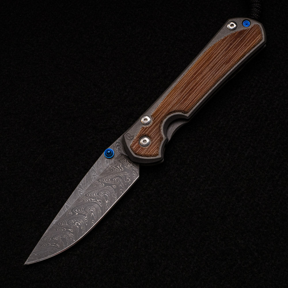 CHRIS REEVE LARGE SEBENZA 31 – NATURAL CANVAS MICARTA – BLUE DOUBLE THUMB LUGS – BOOMERANG BLADE