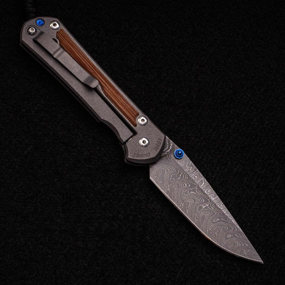 CHRIS REEVE LARGE SEBENZA 31 – NATURAL CANVAS MICARTA – BLUE DOUBLE THUMB LUGS – BOOMERANG BLADE