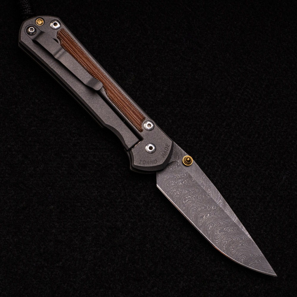 CHRIS REEVE LARGE SEBENZA 31 – NATURAL CANVAS MICARTA – GOLD DOUBLE THUMB LUGS – BOOMERANG BLADE