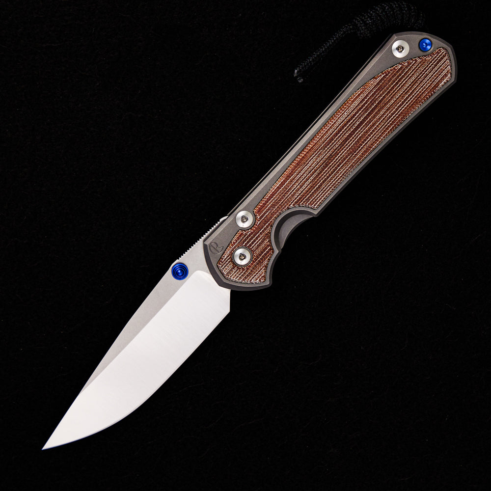 CHRIS REEVE LARGE SEBENZA 31 NATURAL CANVAS MICARTA INLAY – POLISHED CPM MAGNACUT BLADE – GLASS BLASTED – BLUE DOUBLE THUMB LUGS