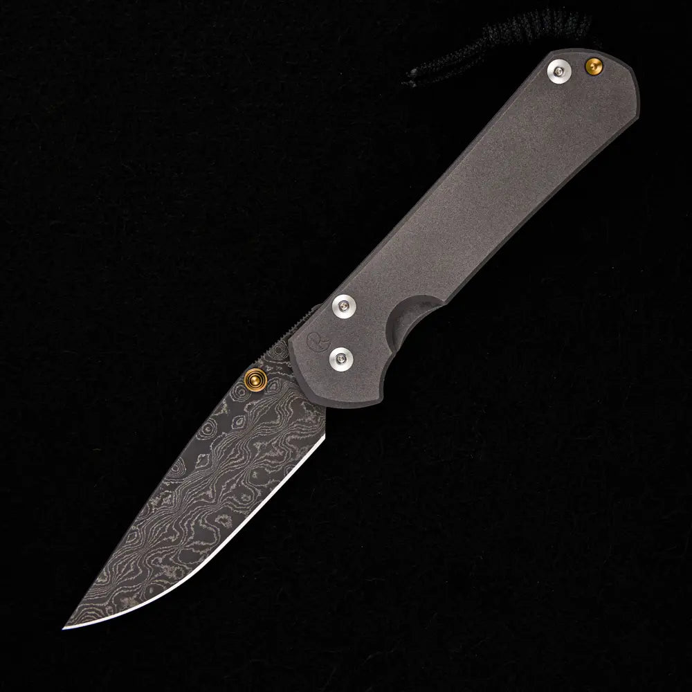 CHRIS REEVE LARGE SEBENZA 31 – GOLD DOUBLE THUMB LUGS – RAINDROP BLADE